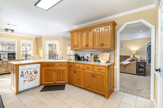 kitchen featuring tile countertops, crown molding, arched walkways, and dishwasher