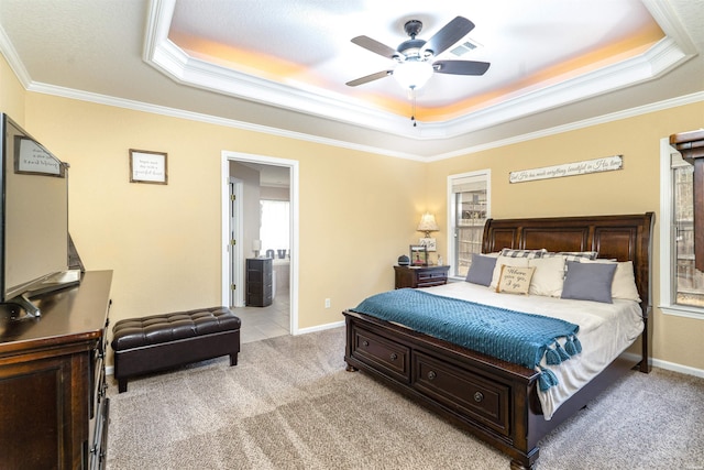 bedroom featuring light carpet, baseboards, ornamental molding, and a raised ceiling