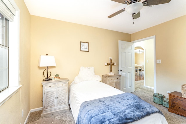 bedroom featuring carpet floors, baseboards, and a ceiling fan