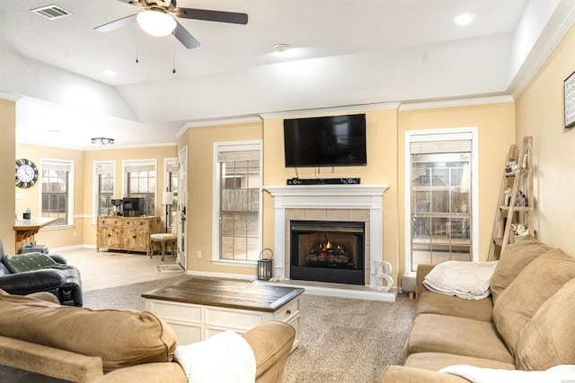 living room with carpet floors, a fireplace, visible vents, baseboards, and vaulted ceiling