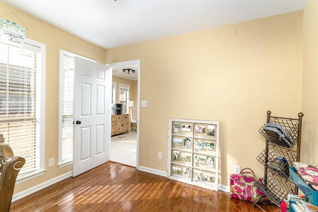 game room with plenty of natural light, baseboards, and wood finished floors