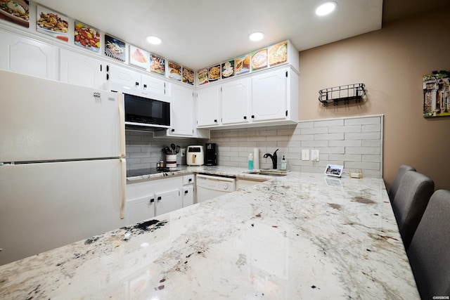 740 Weston Rd Unit A-508, Hot Springs, AR 71913 - kitchen with tasteful backsplash, white appliances, light stone counters, a sink, and white cabinets