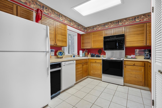 kitchen with brown cabinets, light tile patterned floors, light countertops, a sink, and white appliances