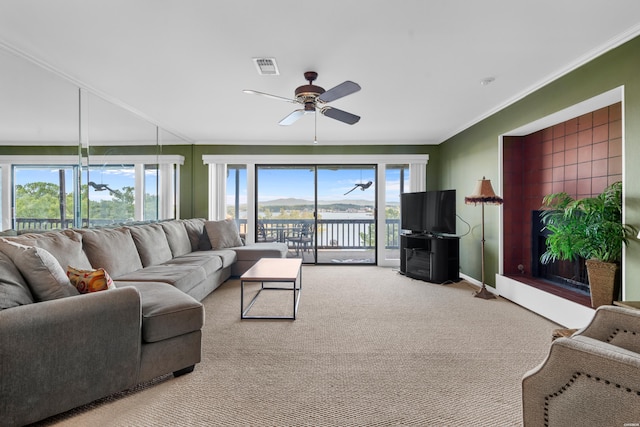 living room with ornamental molding, a wealth of natural light, visible vents, and light carpet