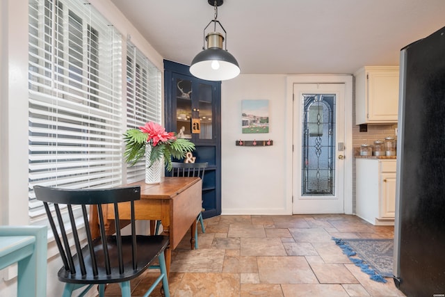 interior space featuring stone finish floor and baseboards