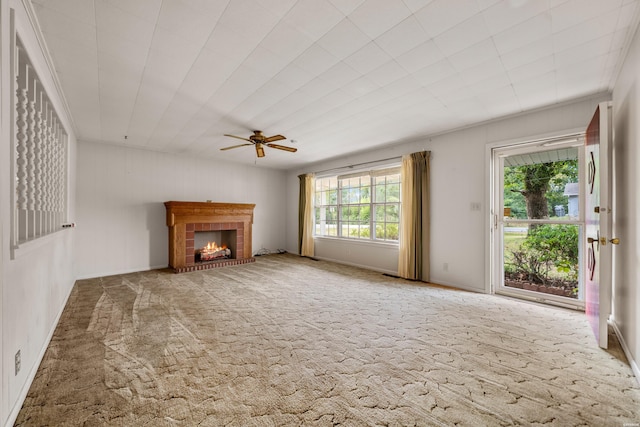 unfurnished living room with carpet, a fireplace, and ceiling fan