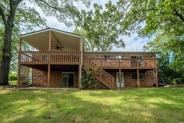 back of house with brick siding, a yard, ceiling fan, a deck, and stairs