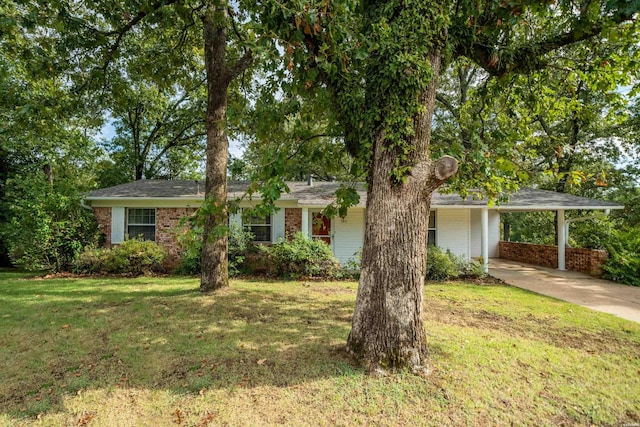 single story home featuring a front yard, brick siding, driveway, and an attached carport