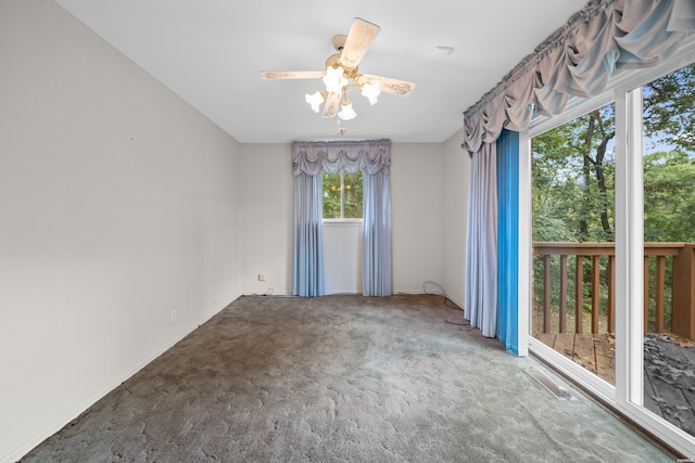 spare room with carpet flooring, ceiling fan, and visible vents