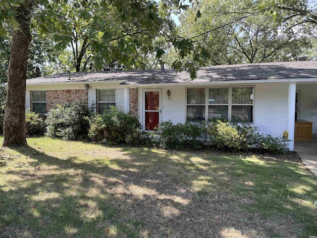 ranch-style house featuring brick siding and a front lawn