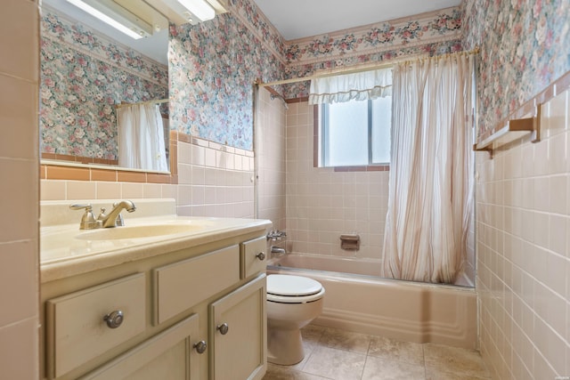 full bath featuring wallpapered walls, shower / bath combo, toilet, tile patterned flooring, and tile walls