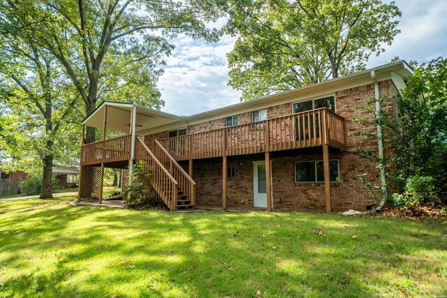 back of house with brick siding, a lawn, stairway, and a wooden deck