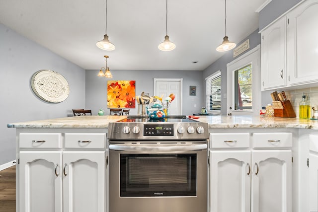 kitchen featuring white cabinets, decorative light fixtures, and stainless steel electric range