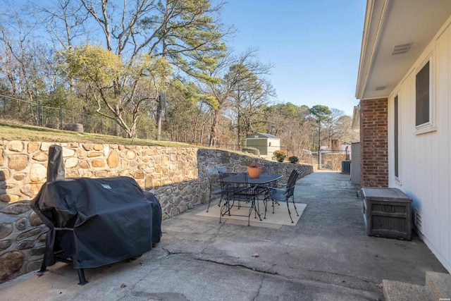 view of patio / terrace featuring outdoor dining area, a fenced backyard, visible vents, and a grill