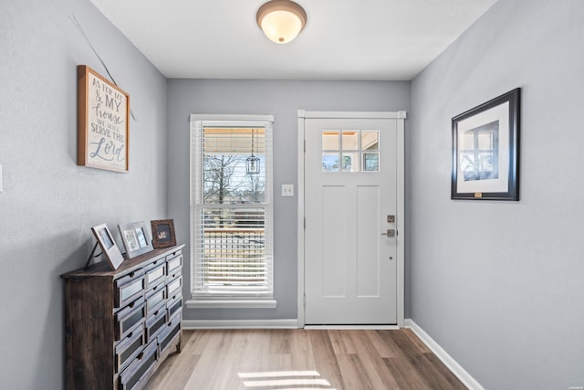 entrance foyer with light wood-style floors and baseboards