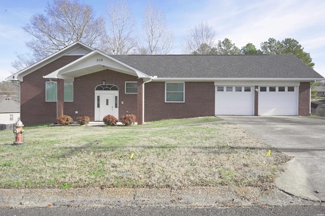 single story home featuring brick siding, roof with shingles, concrete driveway, a front yard, and a garage