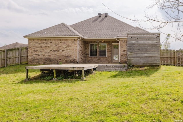 710 Fair Ln, Alexander, AR 72002 - back of house featuring brick siding, a lawn, a shingled roof, and a fenced backyard