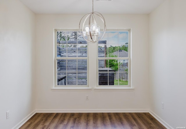 710 Fair Ln, Alexander, AR 72002 - unfurnished dining area featuring visible vents, baseboards, dark wood-style flooring, and an inviting chandelier