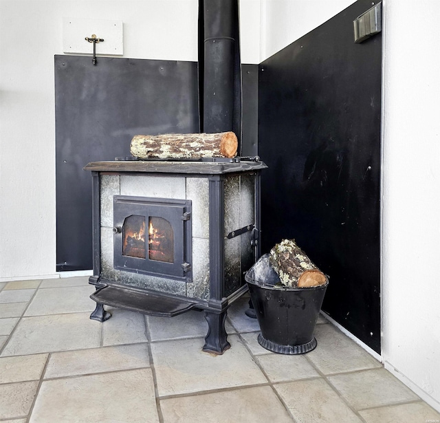 interior details featuring a wood stove and baseboards