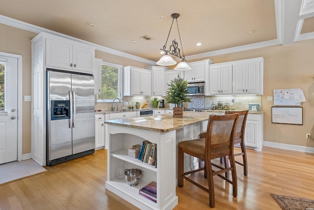 1380 Airport Rd Unit C2, Hot Springs, AR 71913 - kitchen with stainless steel appliances, light wood finished floors, white cabinetry, open shelves, and crown molding