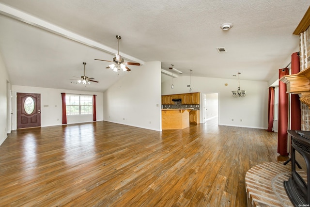 261 Pin Oak Dr, Bismarck, AR 71929 - unfurnished living room with a wood stove, ceiling fan, wood finished floors, a chandelier, and a textured ceiling