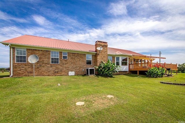 261 Pin Oak Dr, Bismarck, AR 71929 - back of property featuring a chimney, a yard, a metal roof, brick siding, and a wooden deck