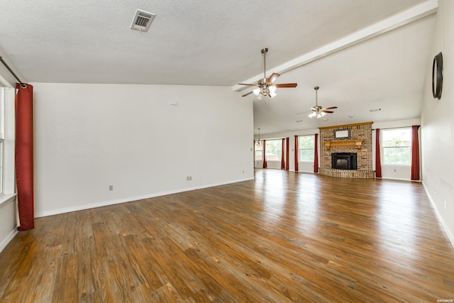 261 Pin Oak Dr, Bismarck, AR 71929 - unfurnished living room with lofted ceiling, a ceiling fan, wood finished floors, a fireplace, and a textured ceiling