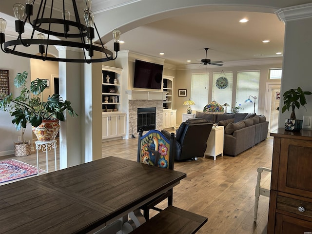 135 Callaway Cir, Hot Springs, AR 71913 - living area with crown molding, arched walkways, ceiling fan, a chandelier, and a stone fireplace