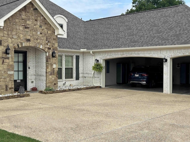 135 Callaway Cir, Hot Springs, AR 71913 - view of property exterior featuring concrete driveway, roof with shingles, a garage, and brick siding