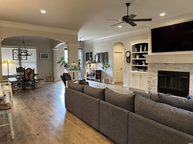 135 Callaway Cir, Hot Springs, AR 71913 - living room featuring arched walkways, ceiling fan, ornate columns, crown molding, and a fireplace