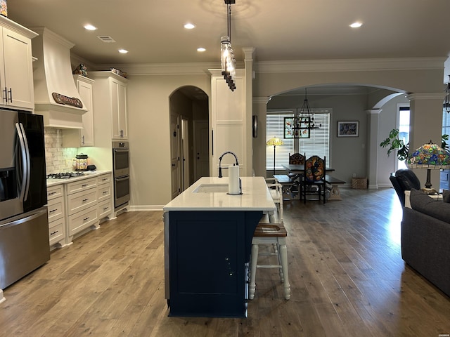 135 Callaway Cir, Hot Springs, AR 71913 - kitchen featuring appliances with stainless steel finishes, premium range hood, arched walkways, decorative columns, and crown molding