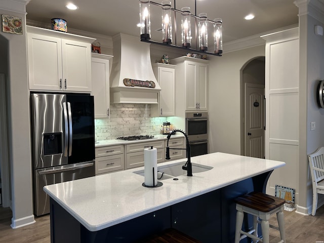 135 Callaway Cir, Hot Springs, AR 71913 - kitchen featuring stainless steel appliances, premium range hood, arched walkways, white cabinets, and ornamental molding