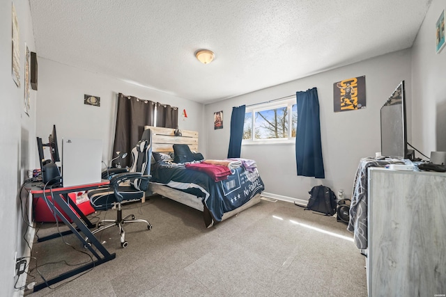 bedroom featuring carpet flooring, a textured ceiling, and baseboards