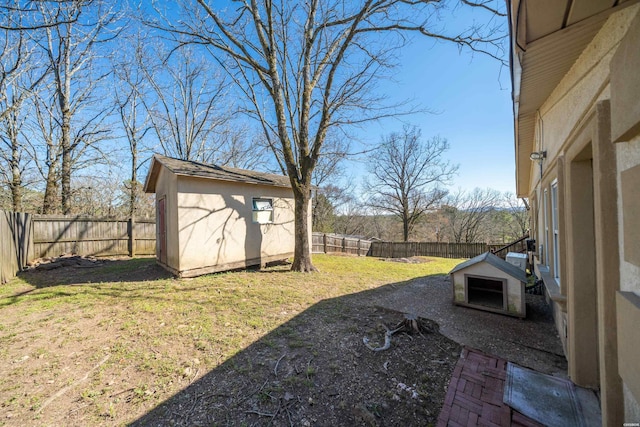 view of yard with a storage shed, an outdoor structure, and a fenced backyard