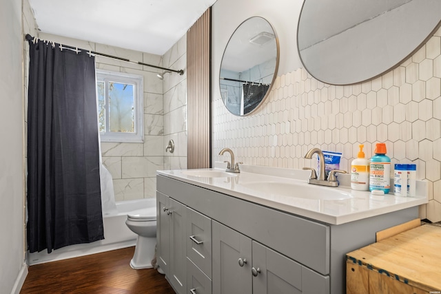 bathroom featuring shower / bath combination with curtain, double vanity, a sink, and tile walls