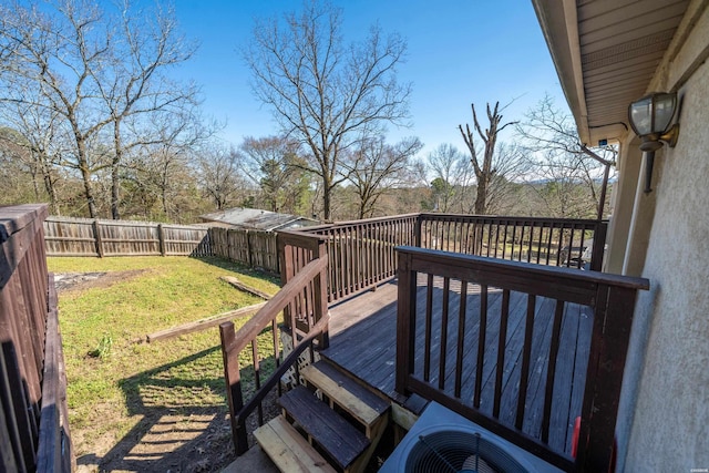 wooden deck featuring a yard, cooling unit, and a fenced backyard