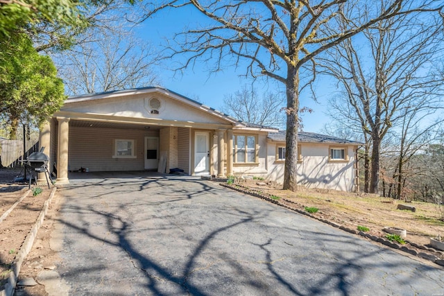 single story home with an attached carport and driveway