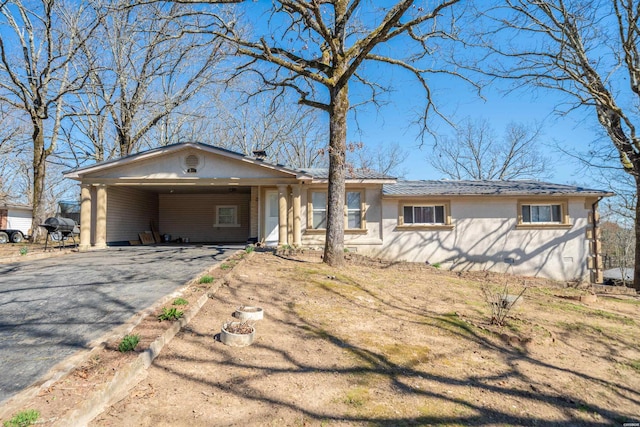 single story home featuring a carport and driveway