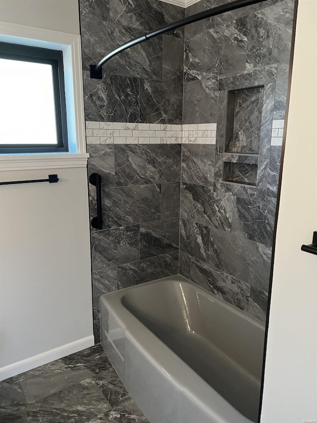 bathroom featuring shower / bath combination, marble finish floor, and baseboards