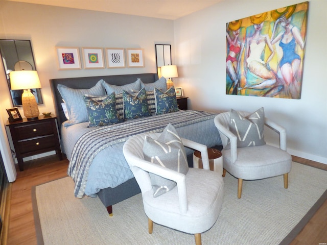 bedroom featuring baseboards and wood finished floors