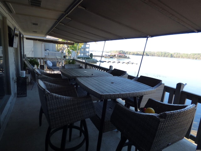 exterior space with outdoor dining area and a water view