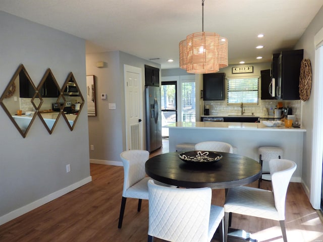 dining area with recessed lighting, wood finished floors, and baseboards