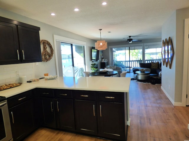 kitchen featuring a wealth of natural light, open floor plan, light countertops, and a peninsula