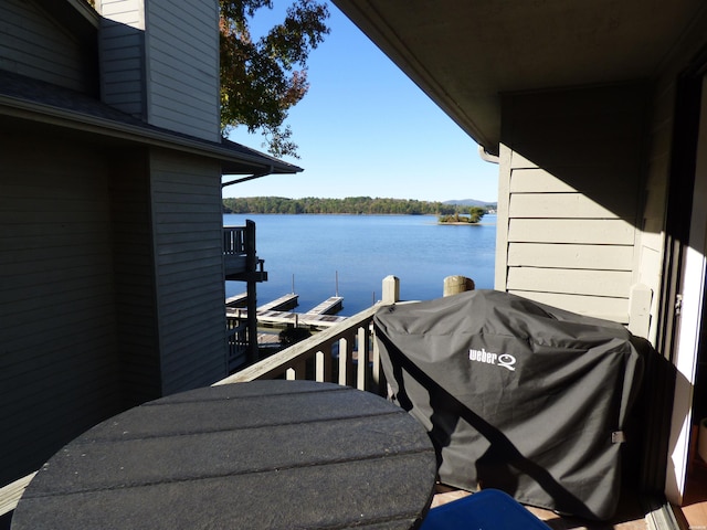 balcony featuring a water view and area for grilling