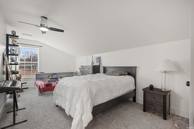 bedroom featuring lofted ceiling, carpet floors, visible vents, baseboards, and a ceiling fan