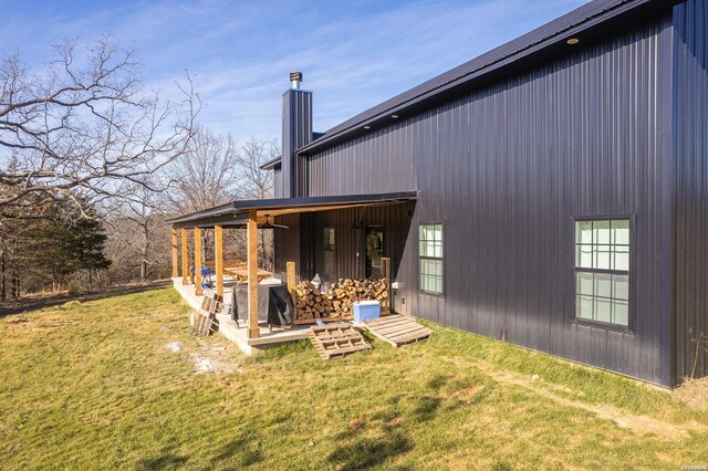 rear view of property with a lawn and a chimney