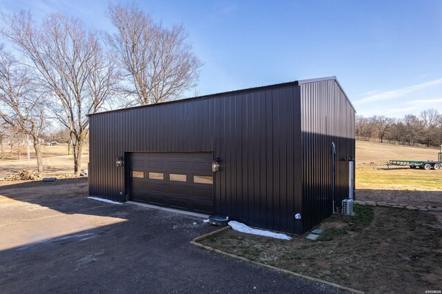 detached garage with dirt driveway