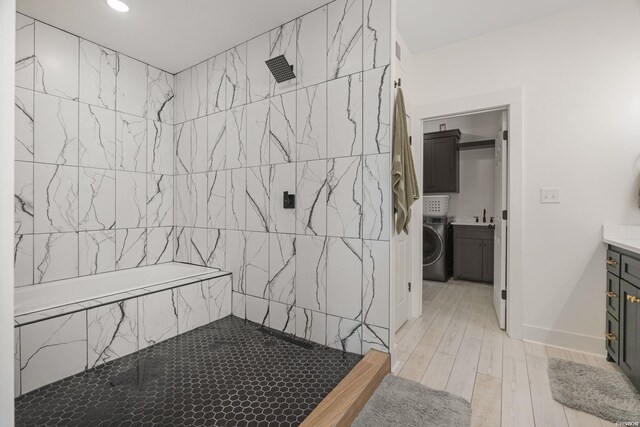 bathroom with washer / dryer, baseboards, wood finished floors, vanity, and recessed lighting