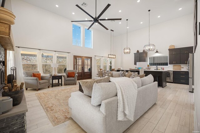 living area featuring visible vents, french doors, light wood-style flooring, and recessed lighting