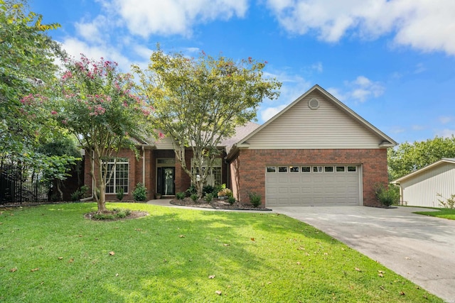 view of front facade with a front lawn, concrete driveway, and brick siding